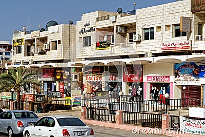 Aqaba, Jordan, March 7, 2018: Main shopping street for tourists with textile and jewellery shops behind colourful facades Editorial Stock Photo