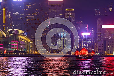 The Aqua Luna sailing in Hong Kong Downtown with skyscraper buildings. financial district in urban city at night. The red boat or Editorial Stock Photo