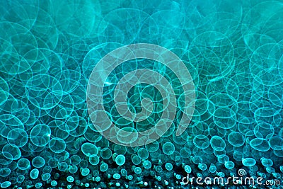 Aquamarine bokeh circles in manual focus on the light source and water highlights. Large space for an elegant Stock Photo