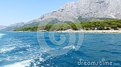Aquamarine water of Adriatic sea in Middle Dalmatia and light gray mountains Stock Photo