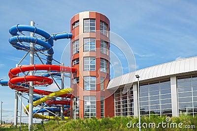 Aquapark bulding outside, Colourful plastic slides Stock Photo