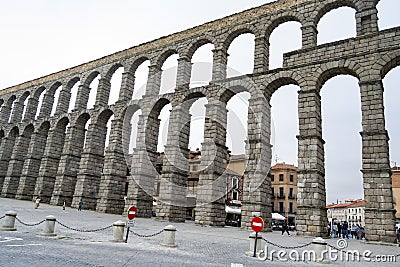 Aqueduct of Segovia. Ancient Roman aqueduct in the Plaza del Azoguejo and old construction cities in Segovia. Spain. Europe. Horiz Editorial Stock Photo