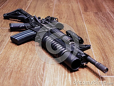 AR15 rifle with grenade launcher on the wooden floor Stock Photo