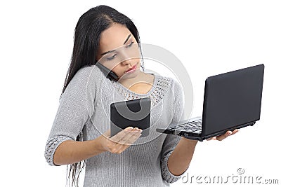 Arab business woman multi tasking busy with phone tablet and computer Stock Photo