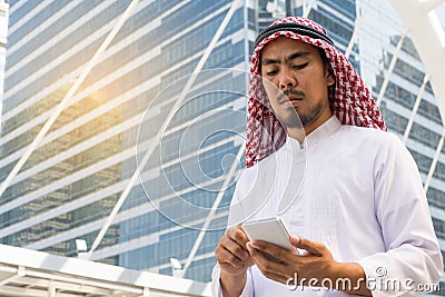 Arab businessman messaging on a mobile phone Stock Photo