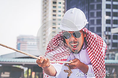 Arab businessman Pull the rope Stock Photo