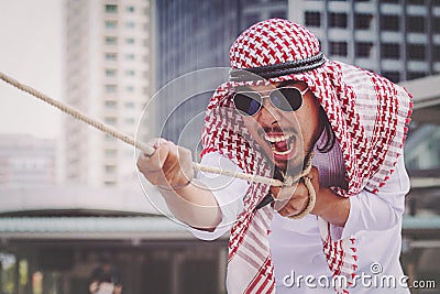 Arab businessman Pull the rope Stock Photo