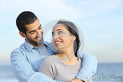 Arab casual couple cuddling happy with love on the beach Stock Photo