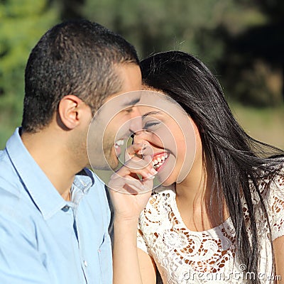 Arab casual couple flirting laughing happy in a park Stock Photo