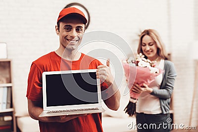 Arab Deliveryman with Laptop and Girl with Flowers Stock Photo