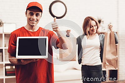 Arab Deliveryman with Laptop and Girl with Packege Stock Photo