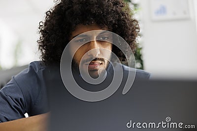 Arab entrepreneur working at financial data and analyzing report Stock Photo