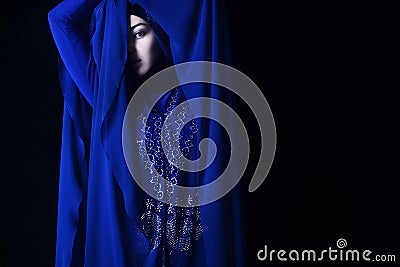 Arab girl in blue hijab, black eye Stock Photo