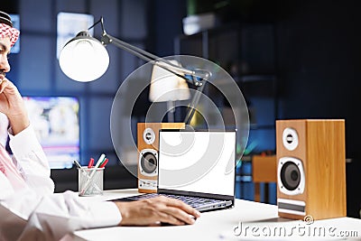 Arab guy has laptop with blank display Stock Photo