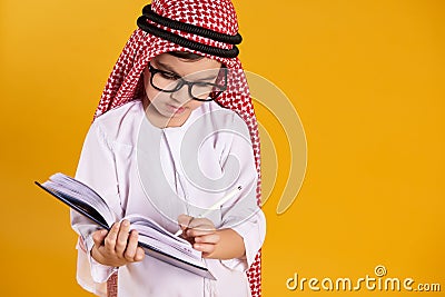 Arab happy boy with glasses makes notes Stock Photo