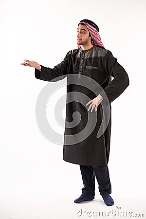Arab indignant man in keffiyeh stands with arm Stock Photo