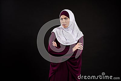 Arab indignant woman in hijab stands Stock Photo