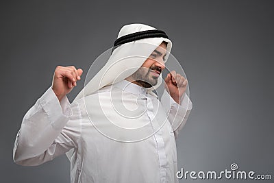 Arab man raising his hands being tired Stock Photo