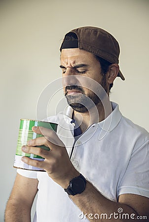 Arab man smelling paint Stock Photo