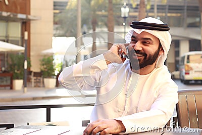 Arab Man Smiling And Speaking In phone Stock Photo