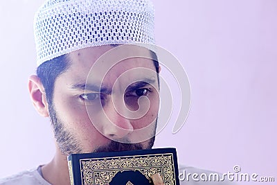 Arab muslim man with koran holy book Stock Photo