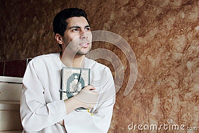 Arab muslim man with koran holy book with rosary Stock Photo