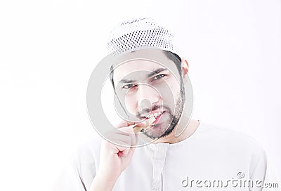 Arab muslim man with toothbrush miswak Stock Photo