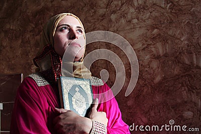 Arab muslim woman with koran holy book wearing hijab Stock Photo