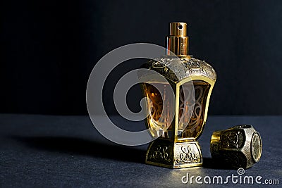 Arab perfume in a bottle, isolated in black background, in low l Stock Photo