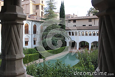 Arab pool of the courtyard of the Alcazar minor with the cloister of the Monastery in front Stock Photo