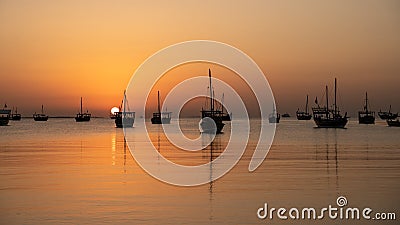 Arab traditional dhows in the shore during the sunrise in Qatar Stock Photo