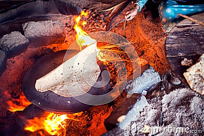 Arab woman makes bread in the beduin village in Egypt Stock Photo