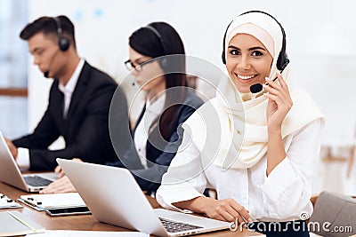 An Arab woman works in a call center. Stock Photo