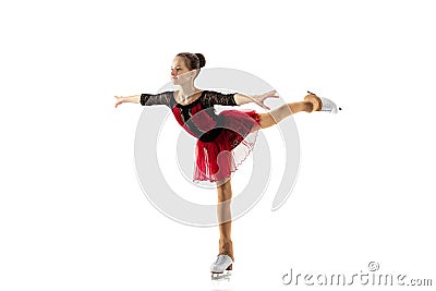 Portrait of little flexible girl, figure skater wearing stage attire posing isolated on white studio backgound. Concept Stock Photo