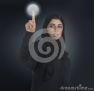 Arabian business woman pressing a touchscreen Stock Photo