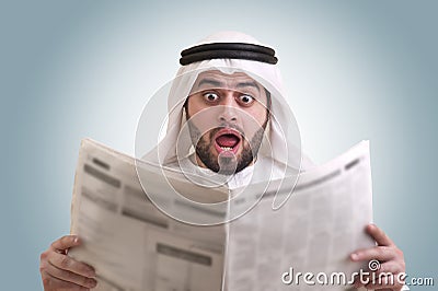 Arabian businessman shocked while reading newspape Stock Photo