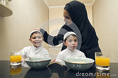 Arabian family of Mother and Two kids having Breakfast in the morning Stock Photo