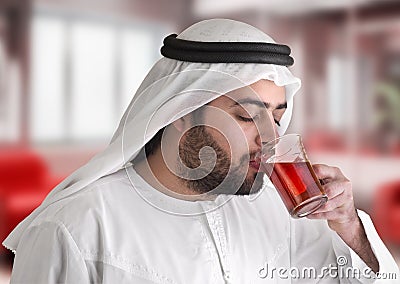 Arabian guy drinking tea / aroma tempting beverage Stock Photo