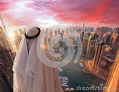 Arabian man is watching Dubai marina in Dubai, United Arab Emirates. Stock Photo