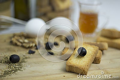 Arabian Mediterranean food ingredient egg, teac, rusk biscuit, black olives, walnut, zaatar, thyme, raisins on wooden platter Stock Photo