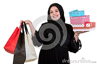 Arabian woman carrying shopping bags and gift boxes isolated on white Stock Photo