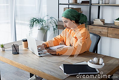 arabian woman in headkerchief typing on Stock Photo