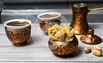 Arabic baklava with coffee in copper cups Stock Photo