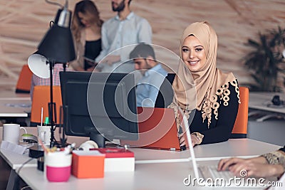 Arabic business woman wearing hijab,working in startup office. Stock Photo