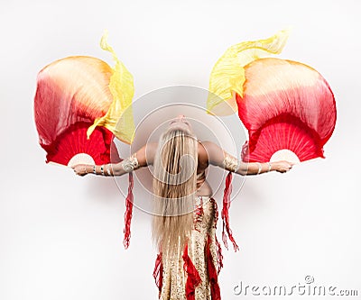Arabic dance with fans and ribbons performed by a beautiful plump woman Stock Photo