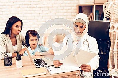Arabic Doctor Reading Medical Examinations Results Stock Photo