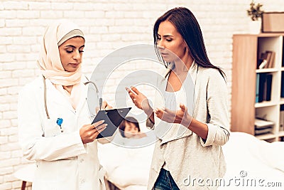 Arabic Doctor`s Appointment Mother with Sick Son Stock Photo