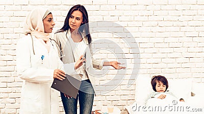 Arabic Doctor`s Appointment Mother with Sick Son Stock Photo