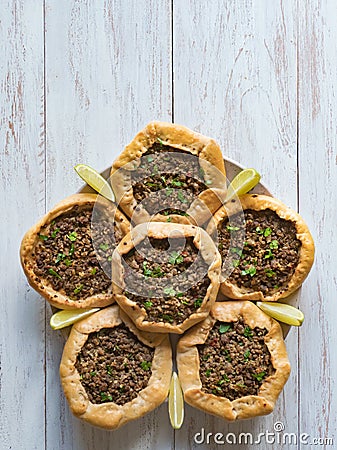 Arabic meat sfiha over a wooden table. Stock Photo