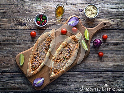 Arabic pizza Lahmacun on dark wooden background. Stock Photo